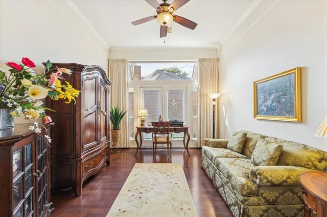 a living room with furniture fireplace and a large window