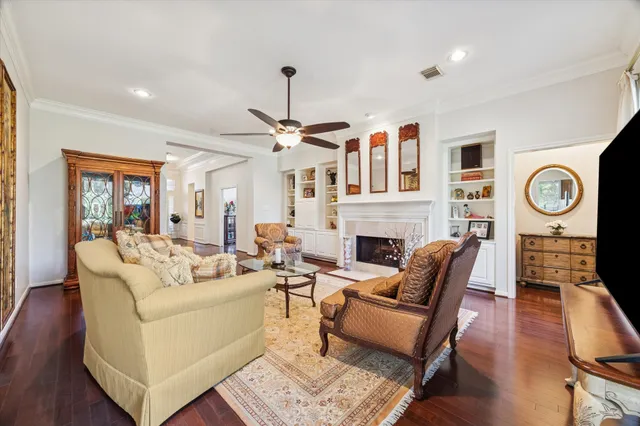a living room with furniture a clock on wall and a fireplace