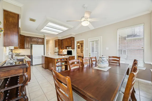 a large kitchen with a table and chairs