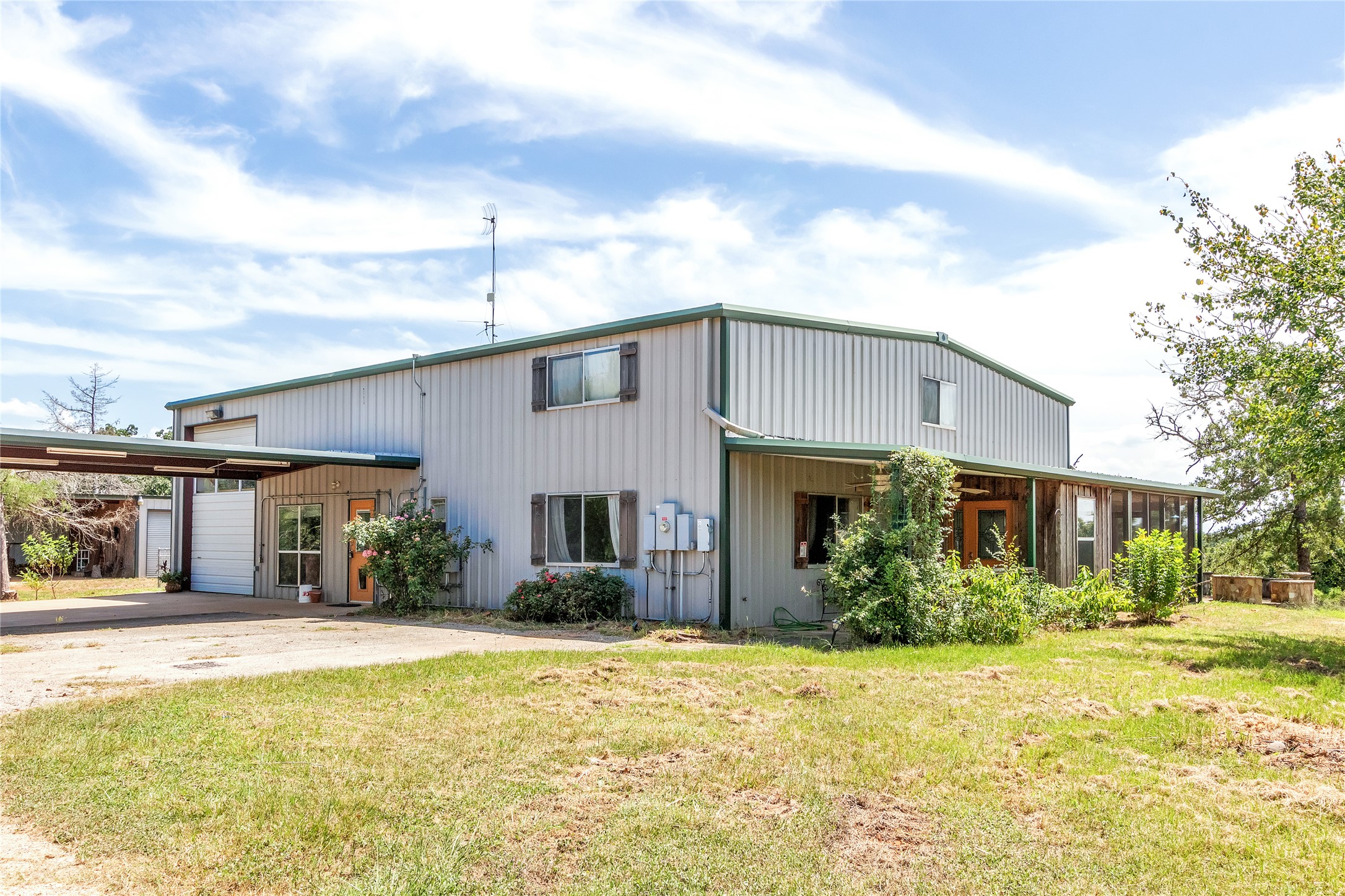 1004 22 Hills Road Gause, TX 77857 - Photo 24 of 37 A metal-sided residence with an integrated carport offers a practical and functional dwelling.
