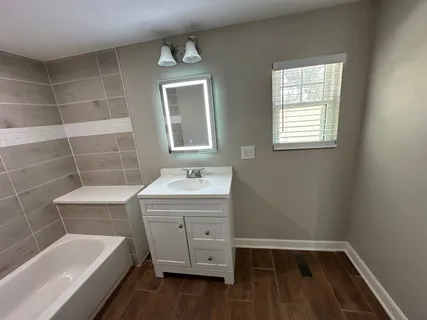 a bathroom with a sink toilet a bathtub and shower