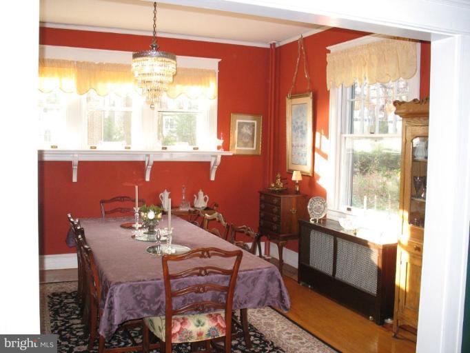5103 Woodside Road Baltimore, MD 21229 - Photo 3 of 30 a view of a dining room with furniture a chandelier and wooden floor