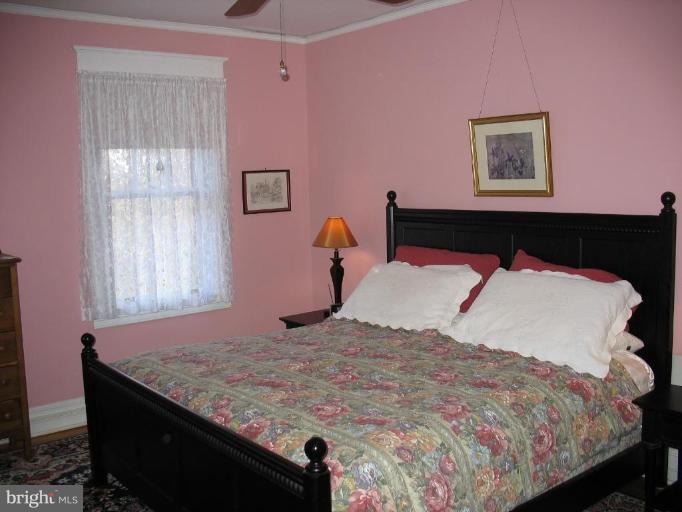 5103 Woodside Road Baltimore, MD 21229 - Photo 22 of 30 a bedroom with a bed and a window