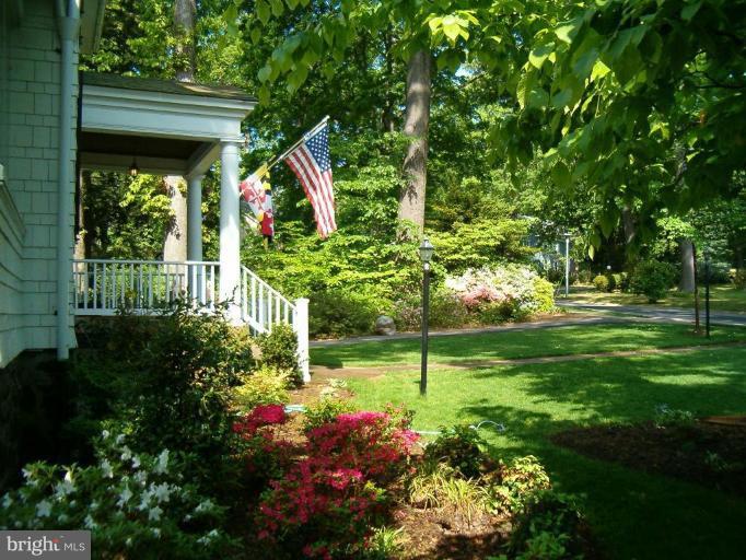 5103 Woodside Road Baltimore, MD 21229 - Photo 26 of 30 a view of a house with a big yard and flower garden