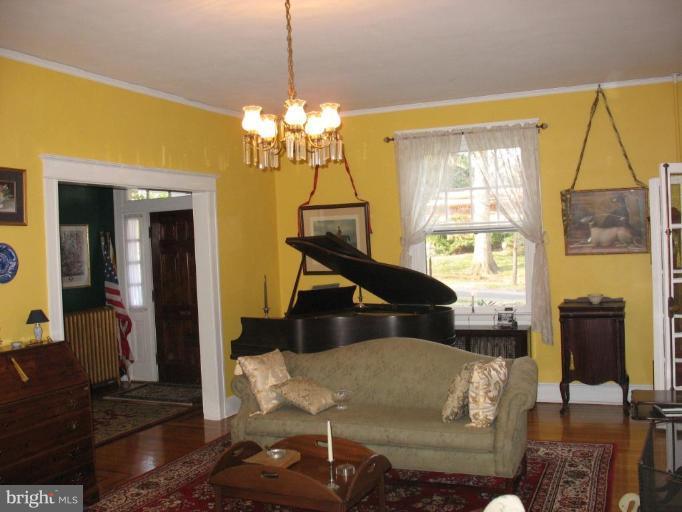 5103 Woodside Road Baltimore, MD 21229 - Photo 6 of 30 a living room with furniture and a chandelier