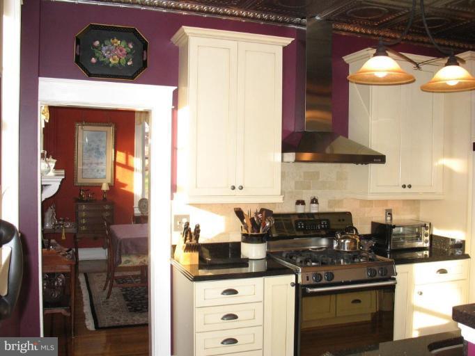 5103 Woodside Road Baltimore, MD 21229 - Photo 8 of 30 a kitchen with a stove a sink and a microwave