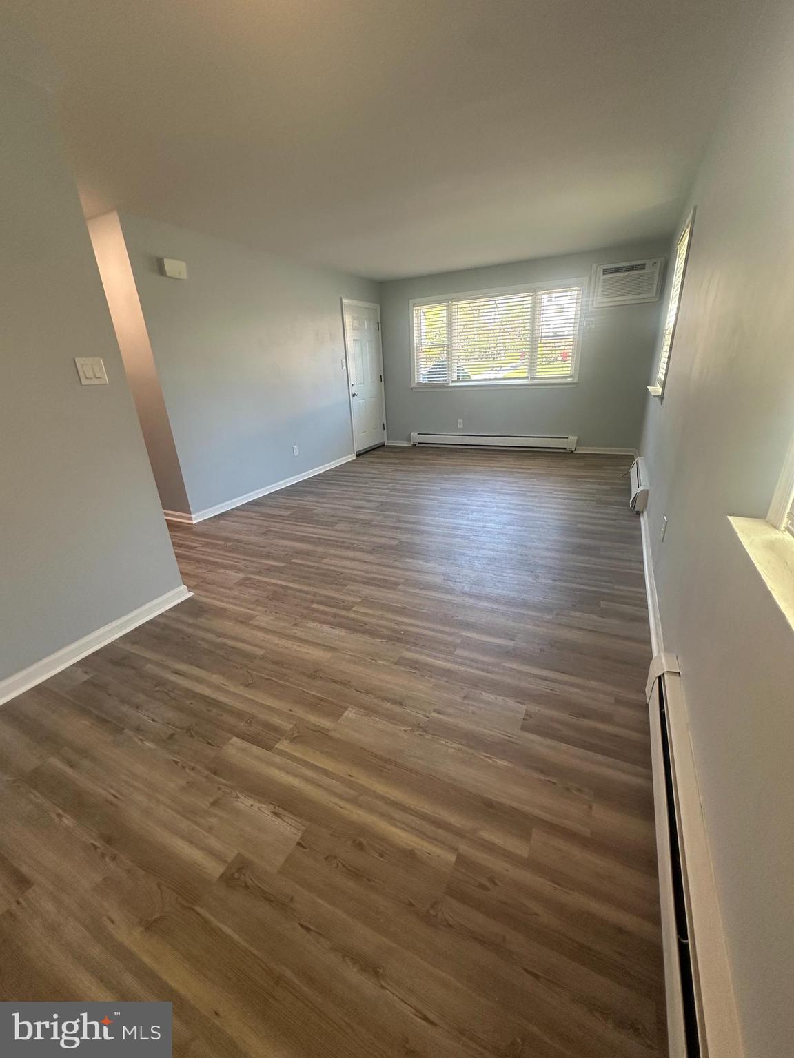 5-7 Thomas Road, Unit 5 Aston, PA 19014 - Photo 4 of 13 a view of wooden floor and windows in an empty room