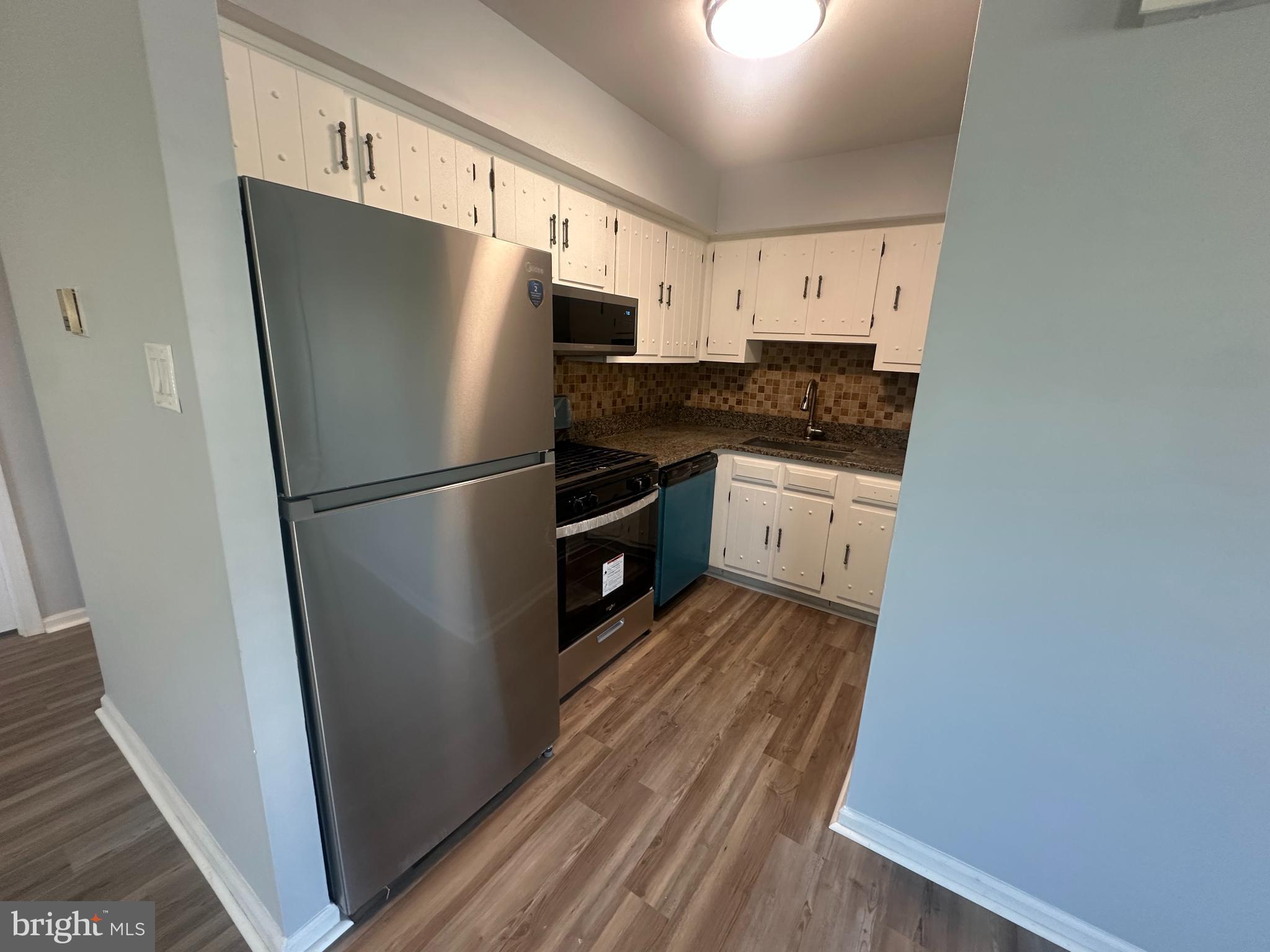 5-7 Thomas Road, Unit 5 Aston, PA 19014 - Photo 5 of 13 a kitchen with a refrigerator a sink and dishwasher