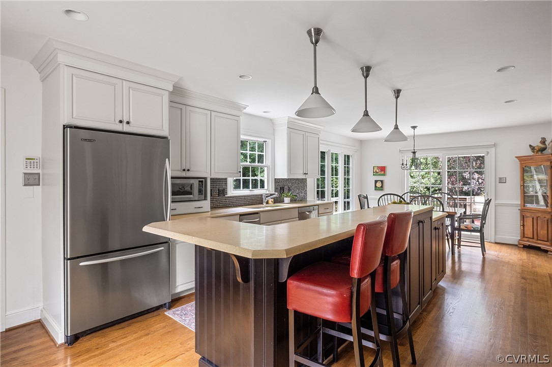 3022 River Hills Lane Midlothian, VA 23113 - Photo 18 of 45 a kitchen with stainless steel appliances a dining table chairs and wooden floor