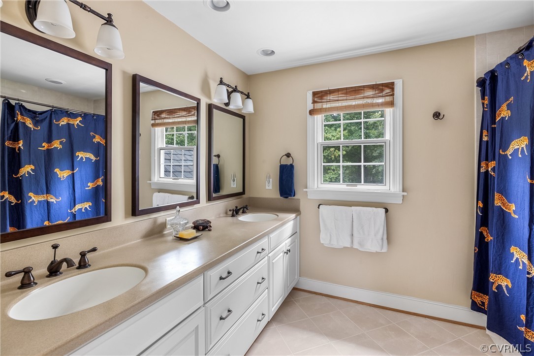3022 River Hills Lane Midlothian, VA 23113 - Photo 32 of 45 a bathroom with double vanity sink a two mirror a window and a shower