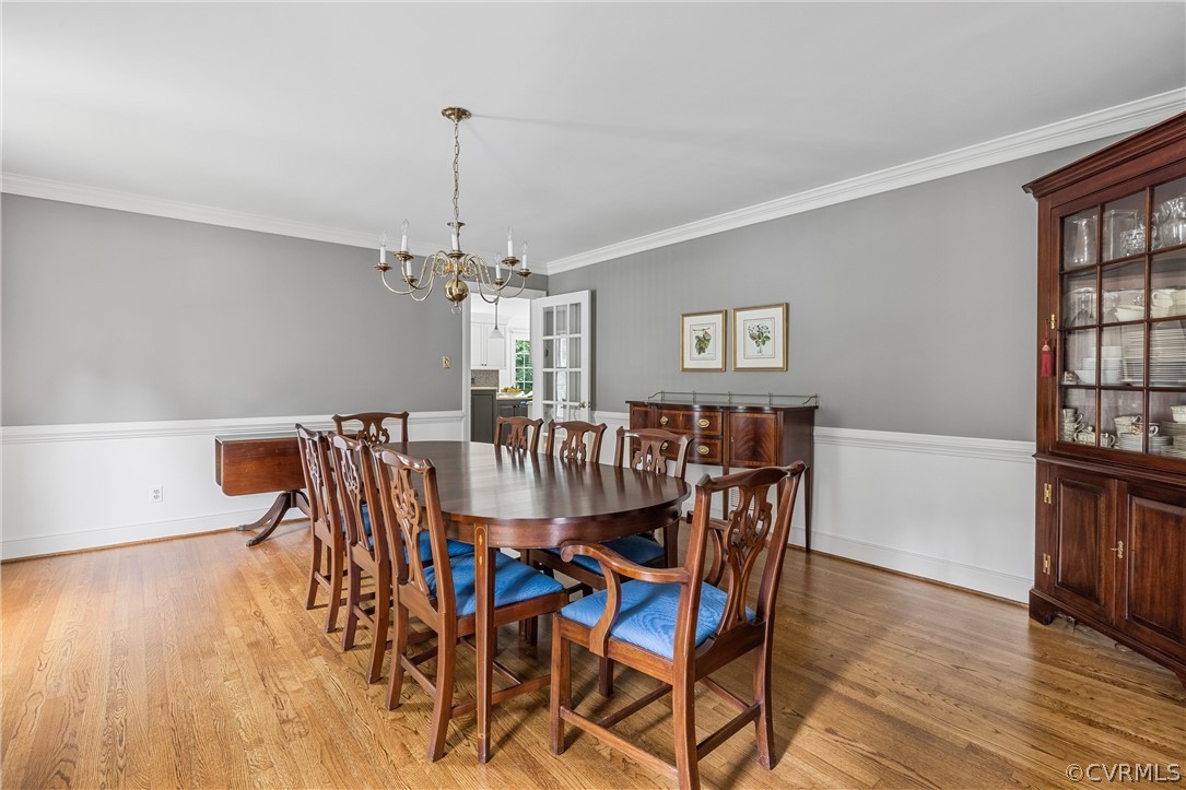 3022 River Hills Lane Midlothian, VA 23113 - Photo 6 of 45 a dining room with furniture a chandelier and wooden floor