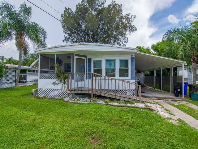 a view of a house with a yard and deck