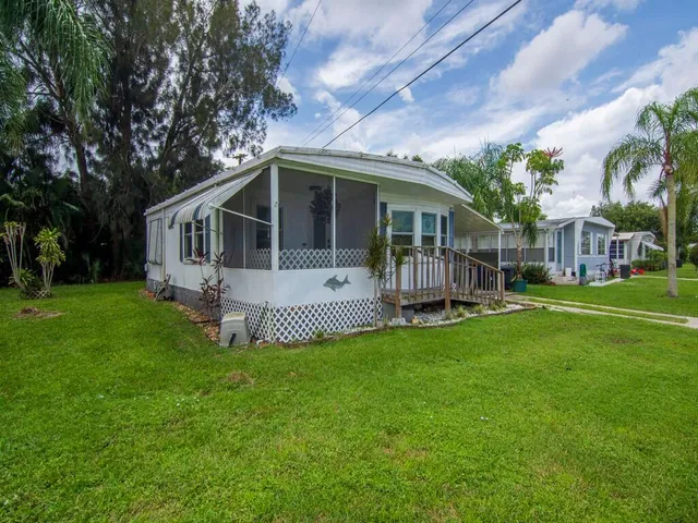 a view of a house with a yard and sitting area