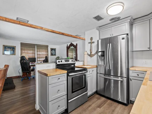 a kitchen with granite countertop stainless steel appliances and wooden cabinets