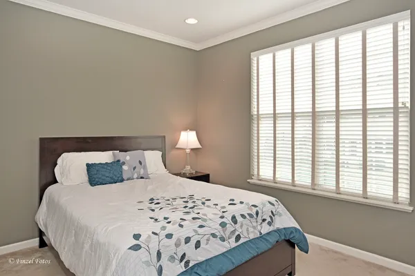 a bedroom with a large bed and a large window