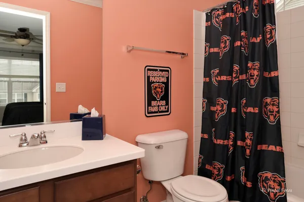 a bathroom with a sink vanity mirror and toilet