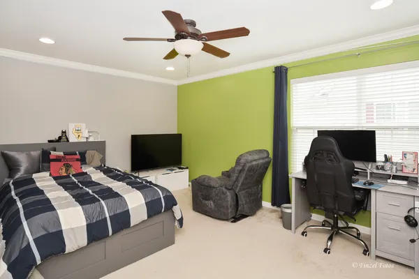 a bedroom with a bed gym equipment and a flat screen tv