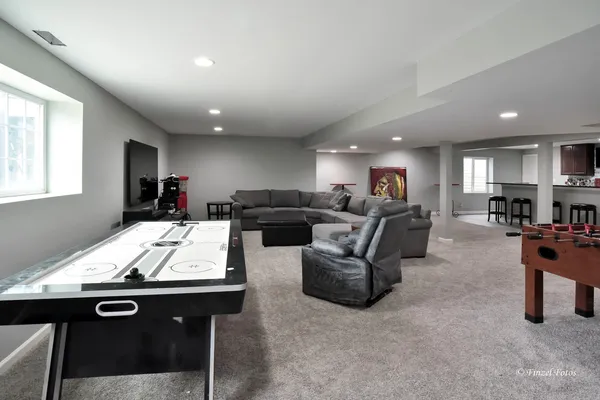 a living room with furniture kitchen view and a large window