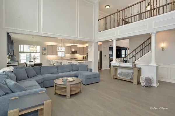 a living room with furniture and a chandelier