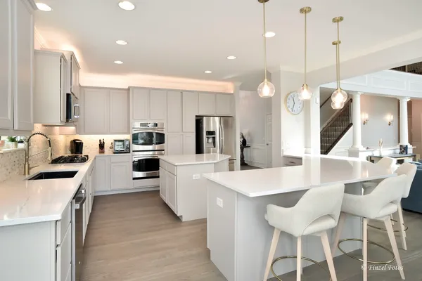 a large kitchen with a table and chairs