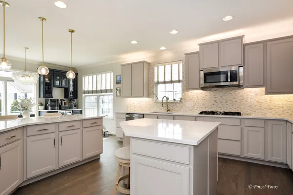 a kitchen with a sink stove and microwave