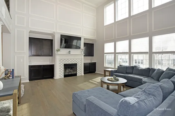 a living room with furniture a fireplace and a flat screen tv