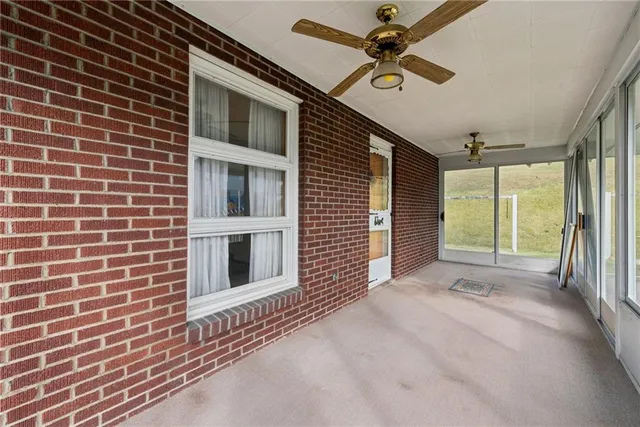 a view of a livingroom with a ceiling fan and window
