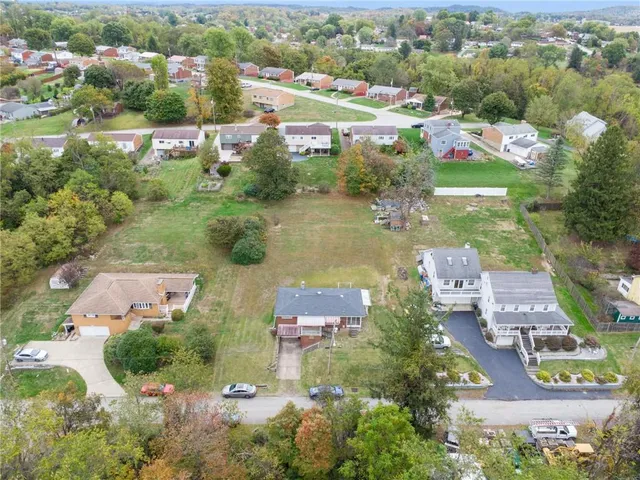 an aerial view of residential houses with outdoor space and river