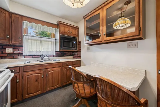 a kitchen with stainless steel appliances a stove a sink and a microwave