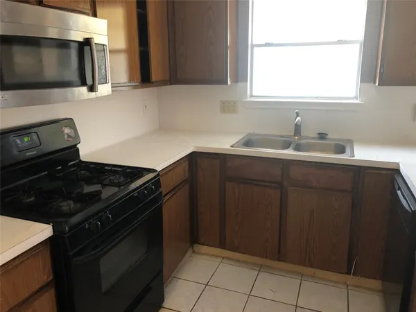 a kitchen with granite countertop a stove and a sink