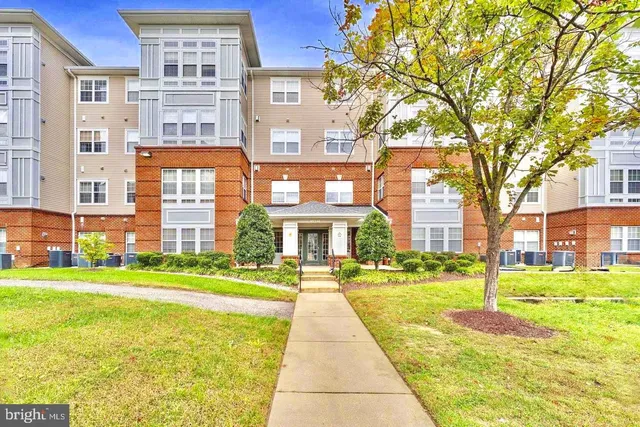 a front view of a building with a garden