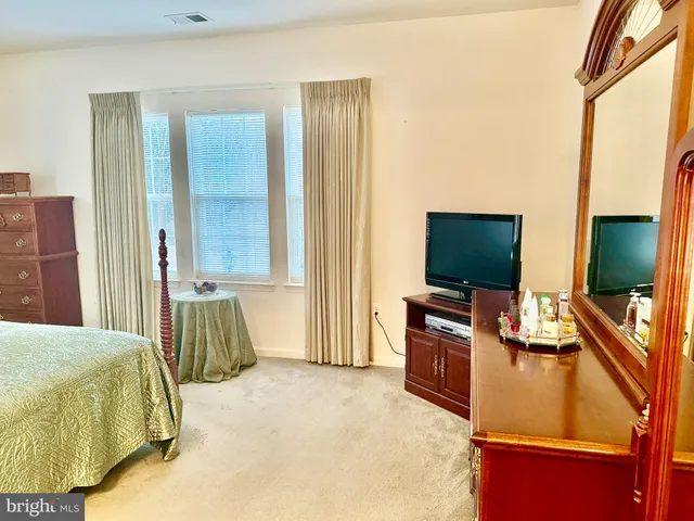 a bedroom with furniture and a flat screen tv