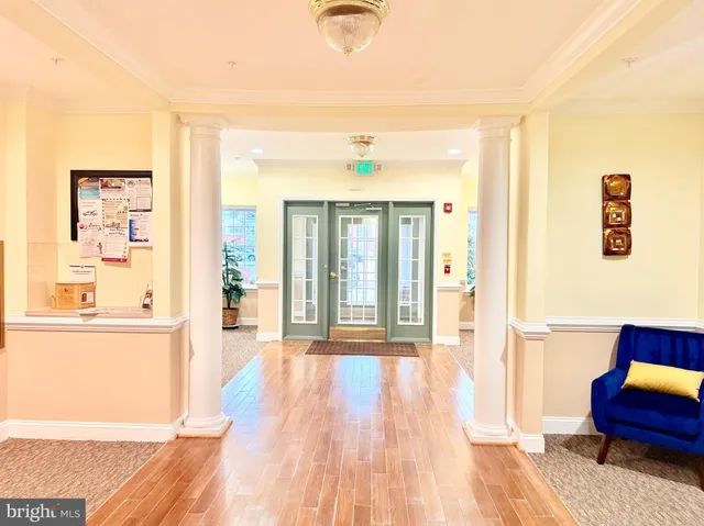 a hallway with wooden floor and windows