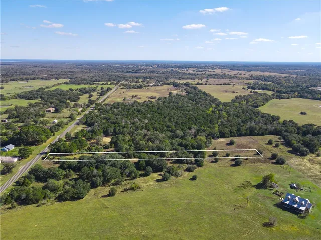 an aerial view of a houses with a yard