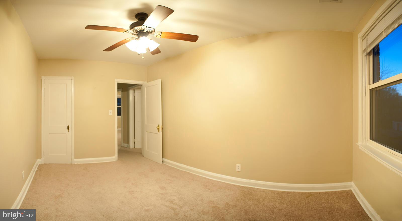 1536 Kingsway Road Baltimore, MD 21218 - Photo 5 of 20 a view of a room with a ceiling fan and a window