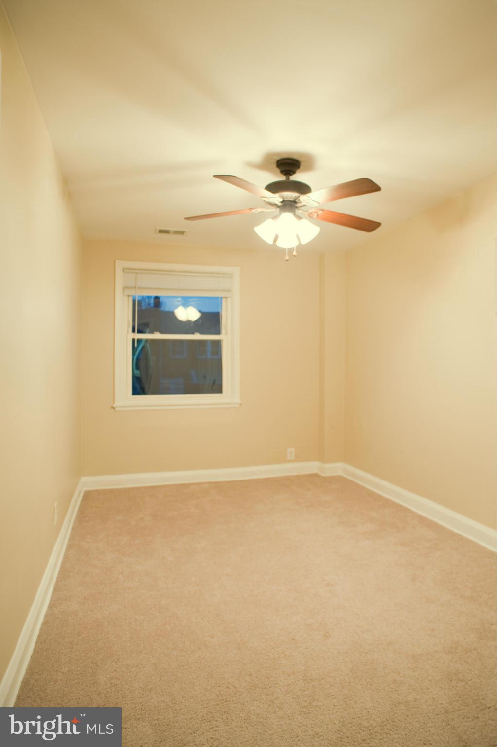 1536 Kingsway Road Baltimore, MD 21218 - Photo 7 of 20 an empty room with windows and fan