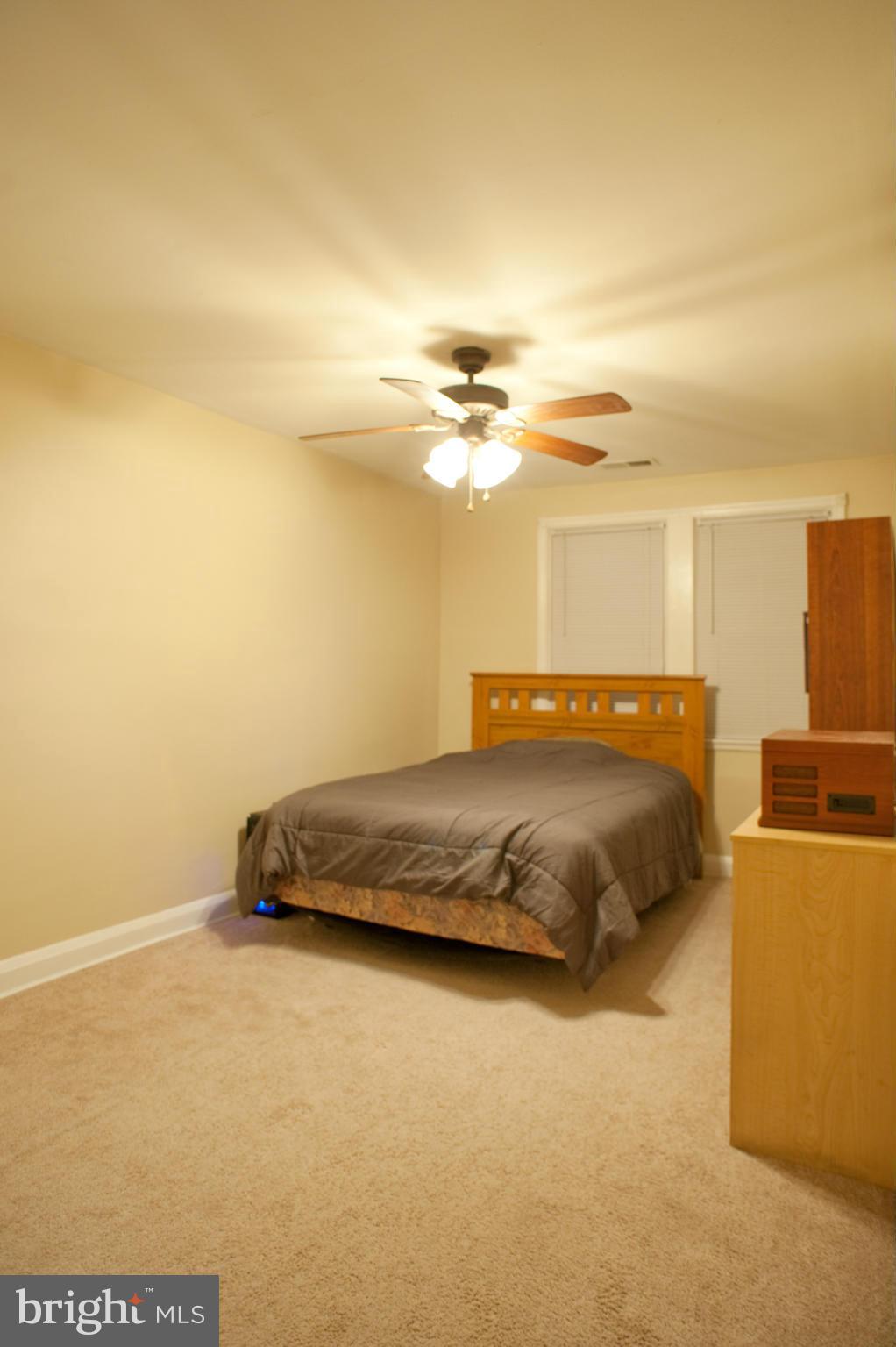 1536 Kingsway Road Baltimore, MD 21218 - Photo 8 of 20 a bedroom with a bed and a cabinets