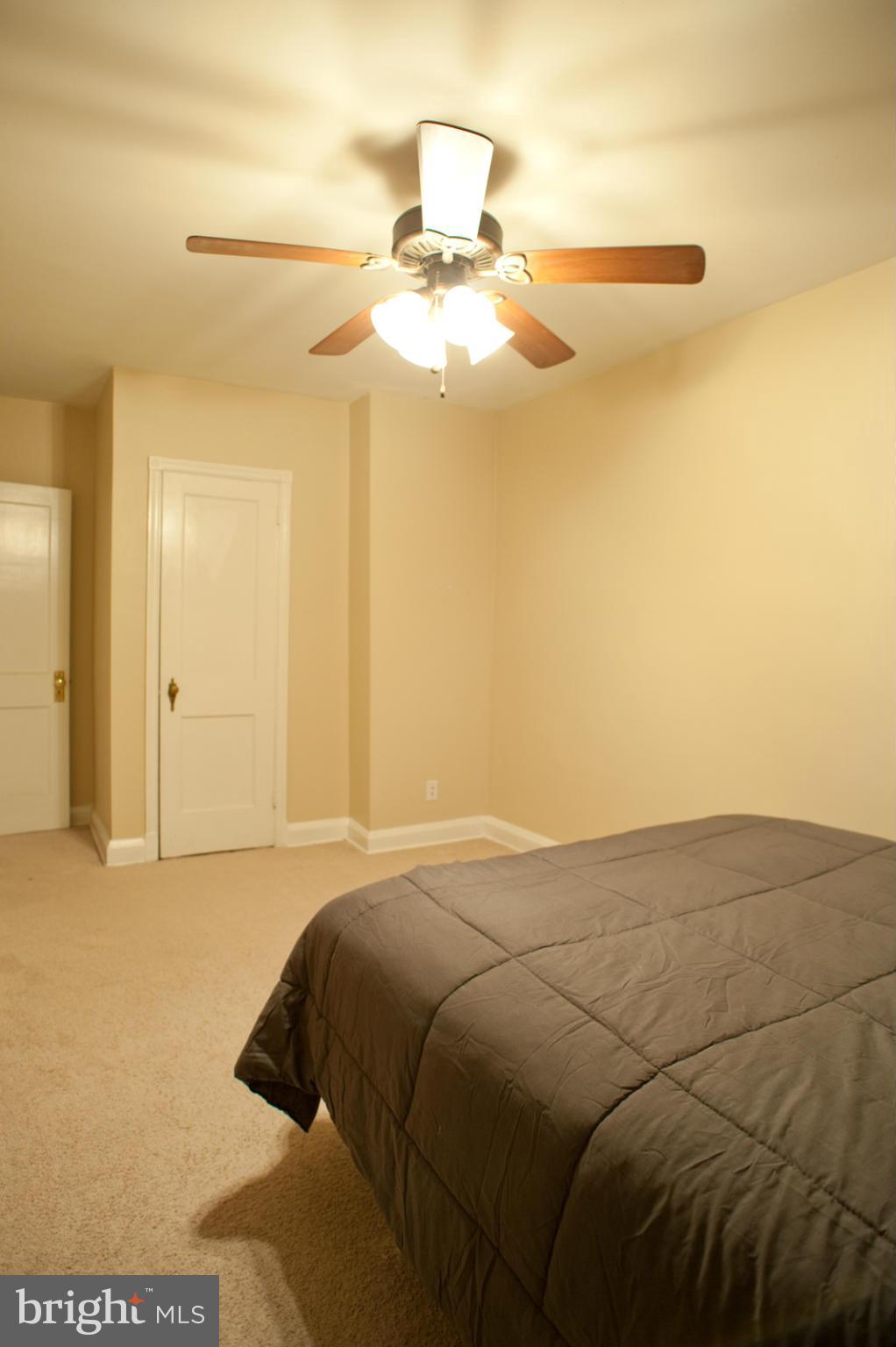 1536 Kingsway Road Baltimore, MD 21218 - Photo 9 of 20 a bedroom with a bed and cabinets