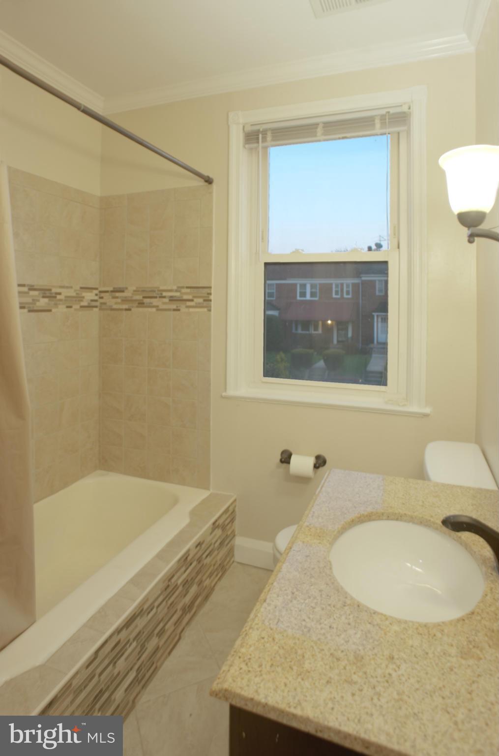 1536 Kingsway Road Baltimore, MD 21218 - Photo 10 of 20 a bathroom with a granite countertop sink and a mirror