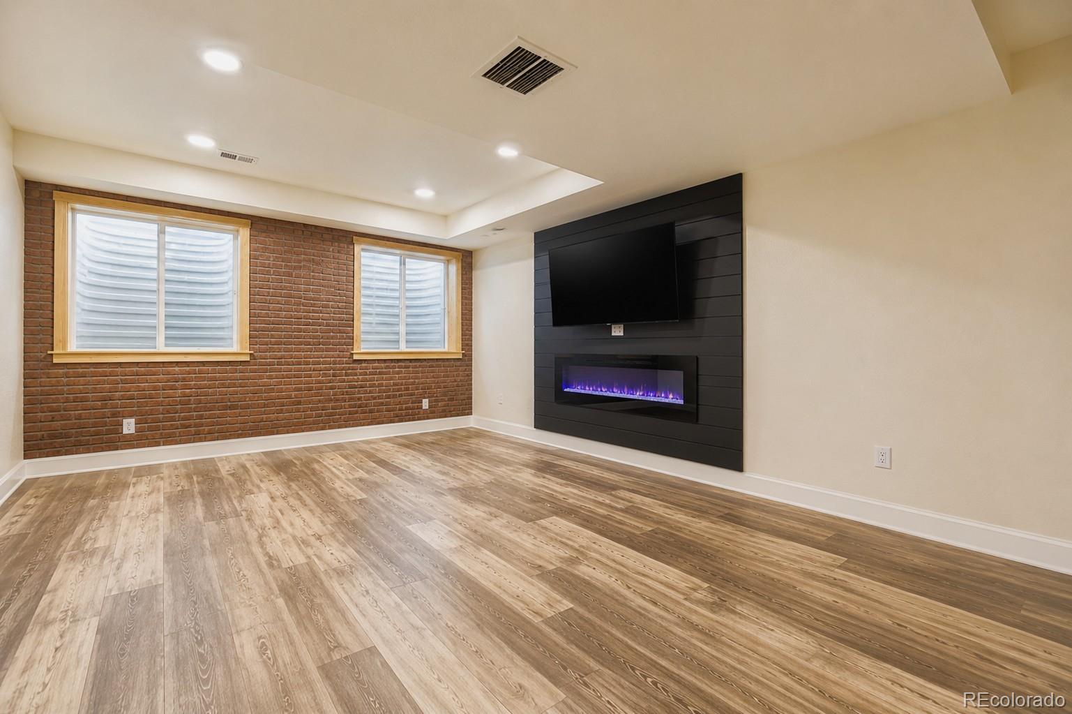 1173 Williams Loop Elizabeth, CO 80107 - Photo 20 of 30 en empty room with window and a flat screen tv