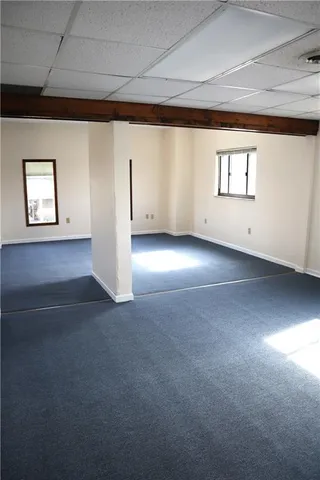 an empty room with windows and closet