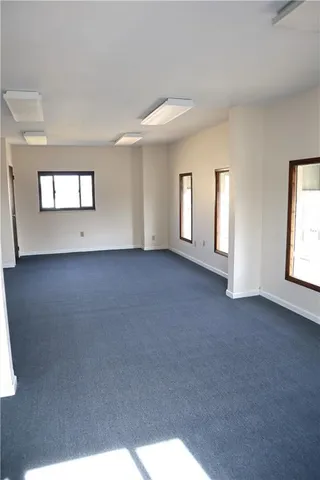 an empty room with windows and closet