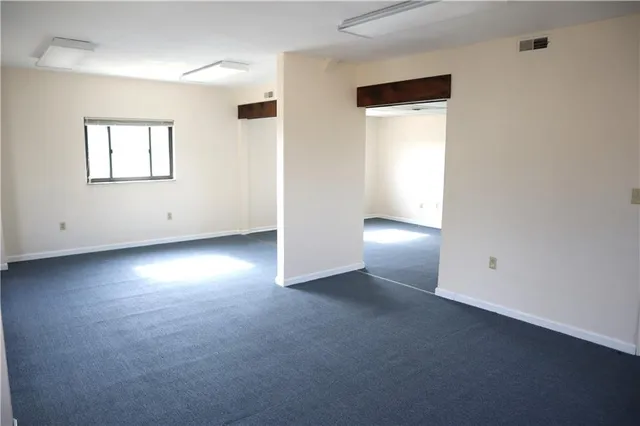 an empty room with a empty space and a window