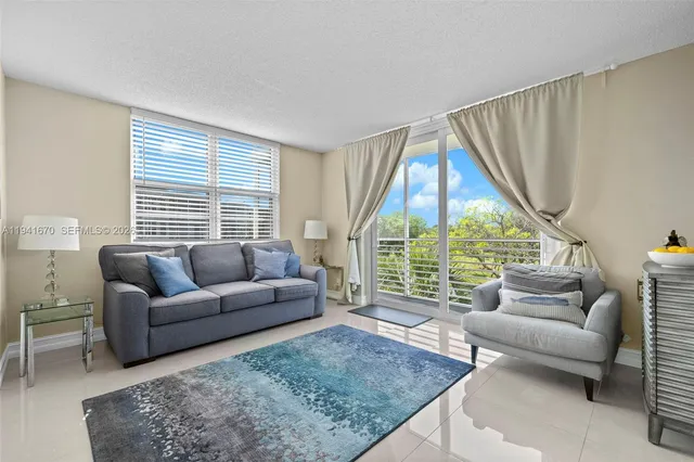 a living room with furniture and a large window
