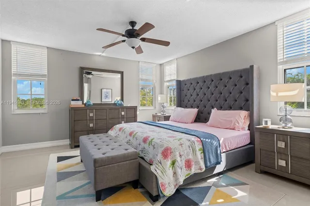 a bedroom with a bed dresser and a window