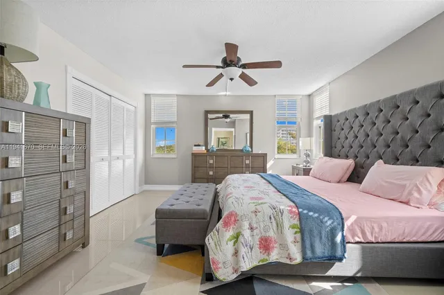 a bedroom with a bed and ceiling fan