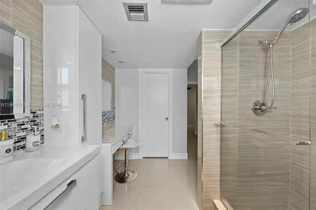 a bathroom with a sink double vanity and shower