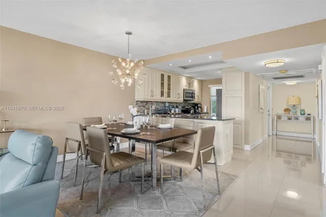 a view of a dining room with furniture and chandelier