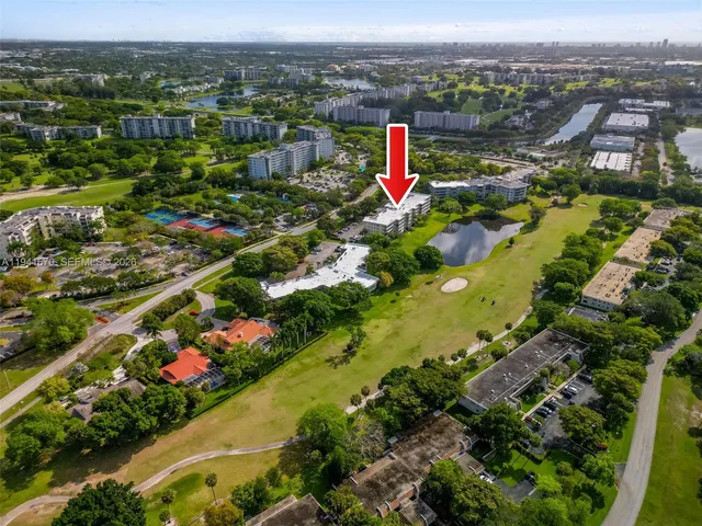 an aerial view of a house with a yard and garden