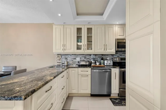 a kitchen with stainless steel appliances granite countertop a stove and a sink
